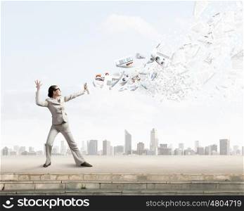 Woman spraying documents. Young businesswoman with suitcase in hand using spray balloon