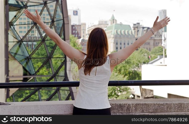 Woman spreads her arms in success