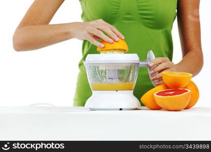 woman squeezes juice by juicer