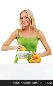 woman squeezes juice by juicer