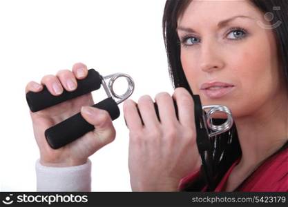 Woman squeezing hand grippers