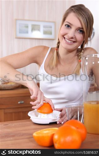 Woman squeezing orange juice