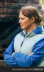 Woman stand next to fireplace at outdoor