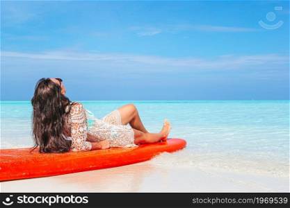 Woman stand up paddling in the ocean. Woman surfing in the sea on vacation