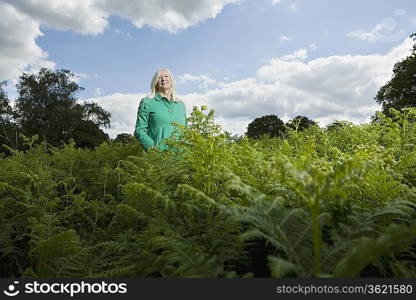 Woman Standing Among Ferns