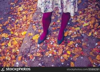 Woman standing amongst leaves