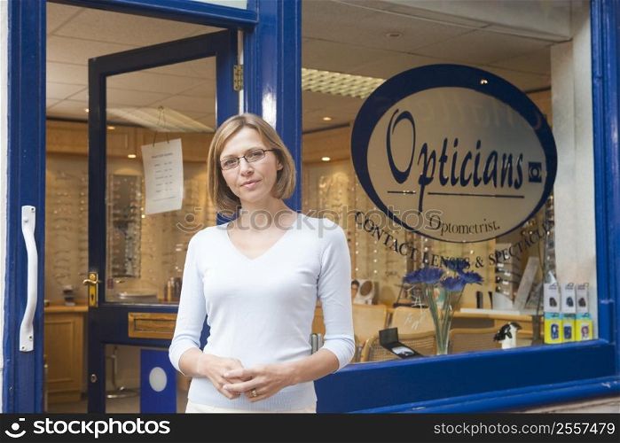 Woman standing at front entrance of optometrists