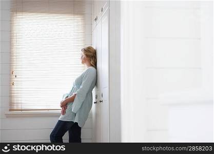 Woman Standing by Bathroom Window