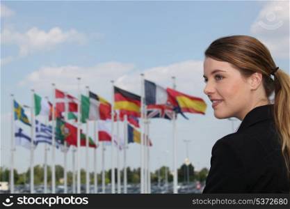 Woman standing by flags