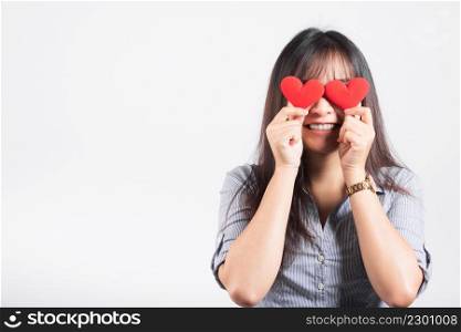 Woman standing her smile confidence cheerful cheery girl holding in hands two red heart symbol cards closing eyes isolated white background, Asian happy portrait beautiful young female valentine
