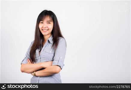 Woman standing her smile confidence with crossed arms isolated white background, Asian happy portrait beautiful young Thai female looking to camera in studio shot on white background and copy space