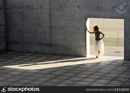 Woman standing in a doorway casting a shadow