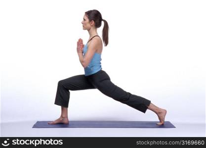 Woman Standing in Balancing Yoga Pose With Leg Stretched Far Back