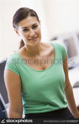 Woman standing in computer room smiling