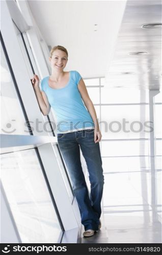 Woman standing in corridor smiling