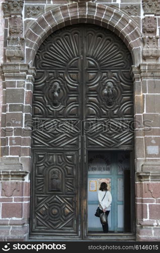Woman standing in doorway, Zona Centro, San Miguel de Allende, Guanajuato, Mexico
