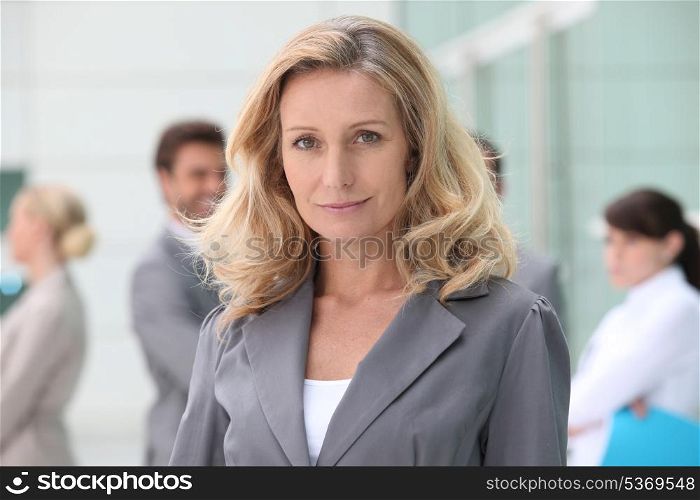 Woman standing in front of her colleagues