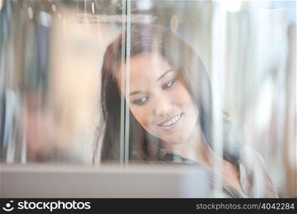 Woman standing in glass case
