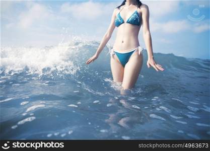 Woman standing in waves at beach