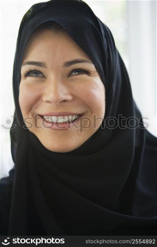 Woman standing indoors smiling (high key)