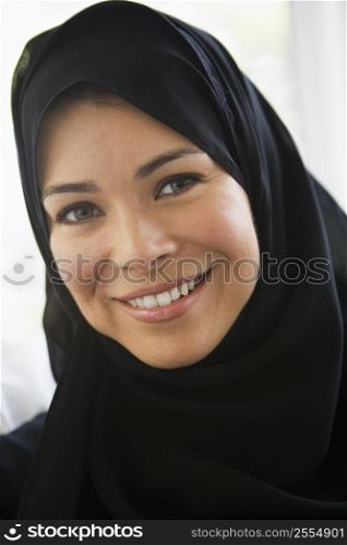 Woman standing indoors smiling (high key)