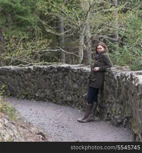 Woman standing near stone wall, Deception Pass State Park, Oak Harbor, Washington State, USA