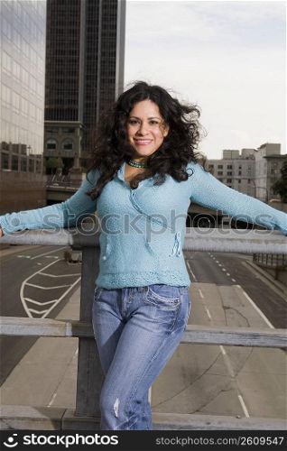 Woman standing on bridge in downtown Los Angeles