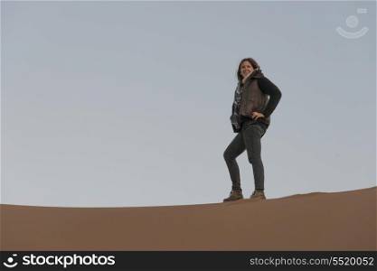 Woman standing on Erg Chegaga Dunes, Sahara Desert, Souss-Massa-Draa, Morocco