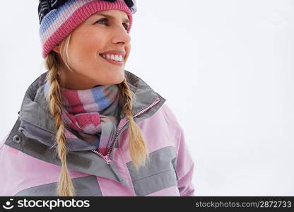 Woman standing on ski slope portrait