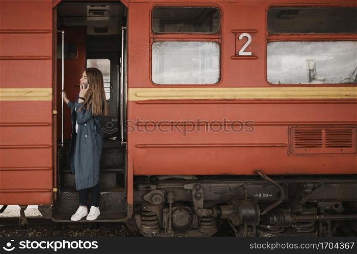 woman standing train entrance looking someone