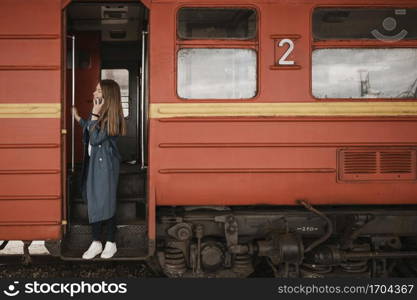 woman standing train entrance looking someone