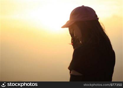 woman standing watching the sunset