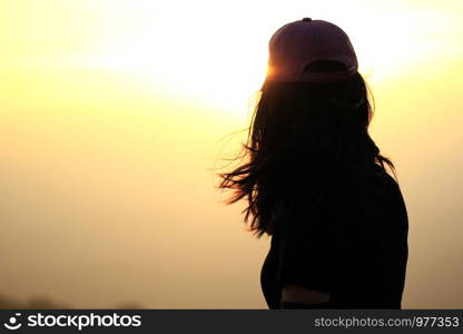 woman standing watching the sunset