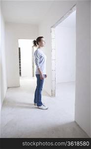 Woman stands in hallway of new apartment