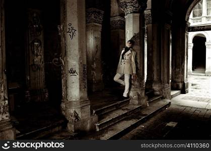 Woman stands in shady doorway, Budapest, Hungary