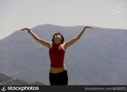 Woman stands looking up at skies of Capileira, Alpujarras, Granada, Andalusia, Spain,