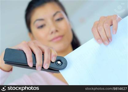 Woman stapling documents