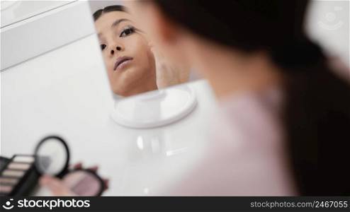 woman staying home using make up