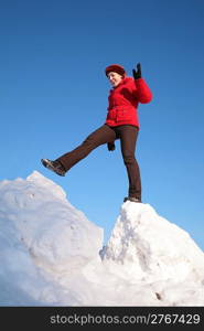 woman steps from one snowy chunk to another