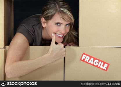 Woman stood amongst boxes