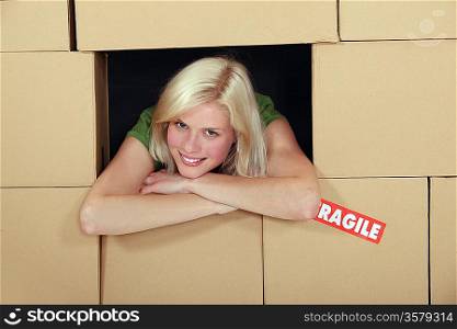 Woman stood amongst cardboard boxes