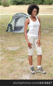 Woman stood by her tent