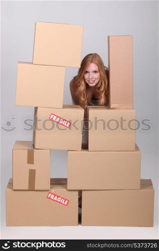 woman stood by pile of cardboard boxes