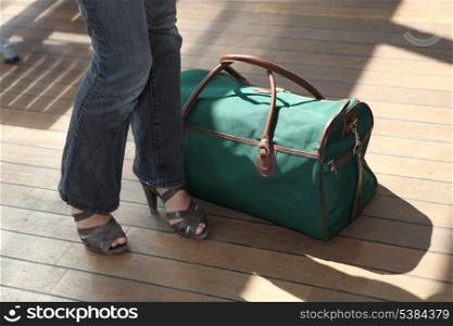 Woman stood next to baggage