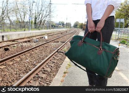 Woman stood waiting on train platform
