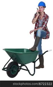Woman stood with empty wheelbarrow