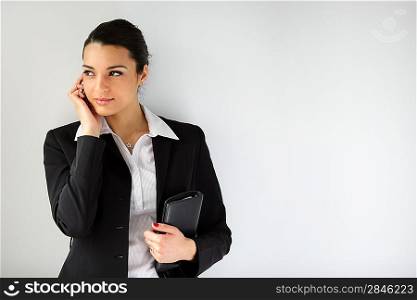 Woman stood with mobile and diary