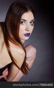 Woman straight long hair make-up posing in studio dark background