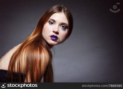 woman straight long hair make-up posing in studio dark background