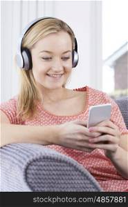 Woman Streams Music From Mobile Phone To Wireless Headphones